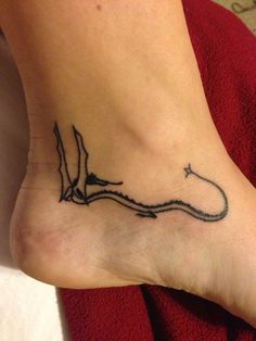 a small tattoo on the foot of a woman