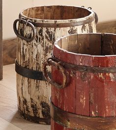 two wooden buckets sitting on top of a wooden floor