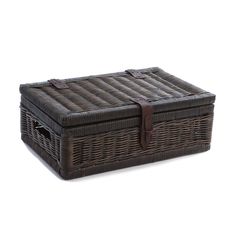 a brown wicker basket with leather handles on a white background for use as a storage container