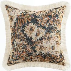 a decorative pillow with fringe trim and floral print on the front, along with a tasseled edge