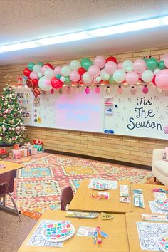 a classroom decorated for christmas with balloons and decorations