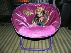 a purple chair with a barbie doll on it's back and the seat up