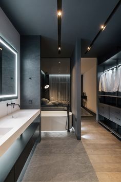 a bathroom with two sinks, mirrors and lights on the wall next to each other