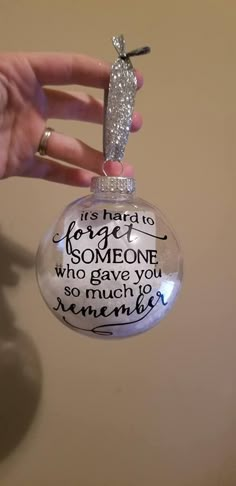 someone is holding up a glass ornament that says it's hard to love someone who gave you so much