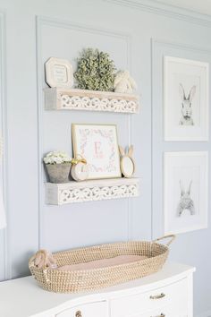 a baby's room with blue walls and pictures on the wall