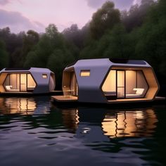 three floating houses are shown in the water at dusk, with lights shining on them