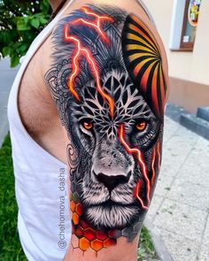 a man's arm with a lion and lightning tattoo on the side of his head