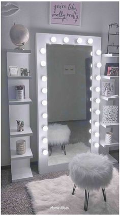 a room with a mirror, stool and lights on the wall above it in front of a book shelf