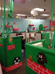 an office cubicle decorated in green and red with mario bros decorations on the walls