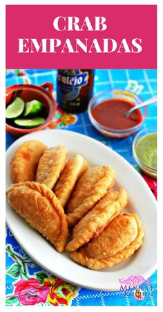 crab empanadas on a white plate with dipping sauce and condiments