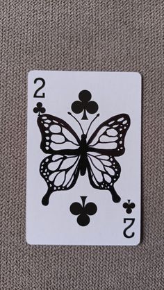 a playing card with a butterfly on the front and numbers 2 - 3 in the back