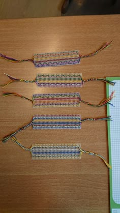 four different types of wires laid out on top of a wooden table next to a piece of paper