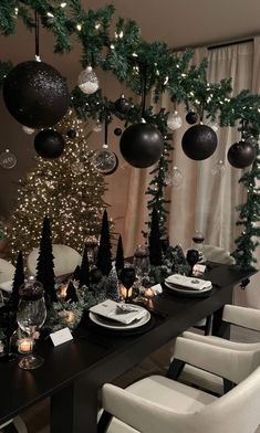 a dining room decorated for christmas with black and white decorations