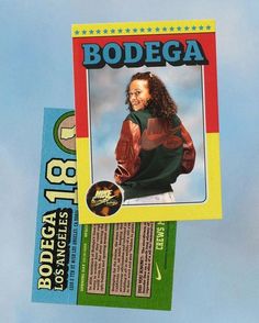 a card with the name bodega on it is hanging from a string in front of a blue sky