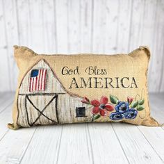 a pillow with an american flag on it and the words, god bless america written in black