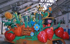 a car decorated to look like a garden with strawberries and sunflowers