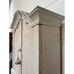 an old white cupboard with some knobs on it