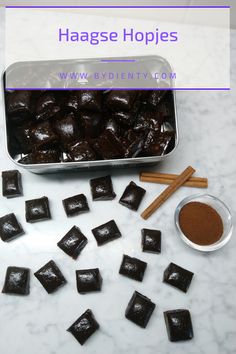 chocolate squares and cinnamon sticks on a marble counter top with text overlay that reads haage holipies