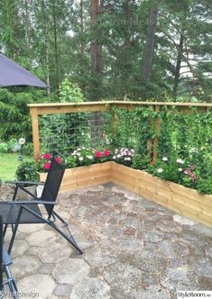 a patio with an umbrella and some flowers