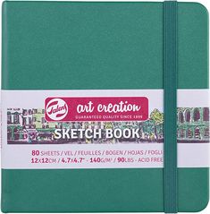 the art creation sketch book is green and has a white strip on top of it