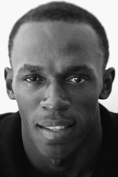 a black and white photo of a man looking at the camera with an intense look on his face