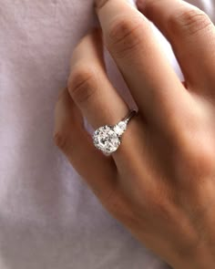 a woman's hand with a diamond ring on it