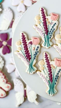 cookies decorated with flowers on a white plate