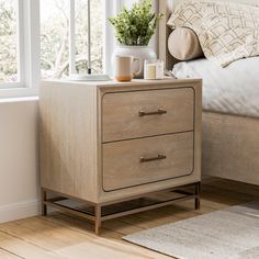 a bedroom with a bed, two nightstands and a coffee cup on the end table