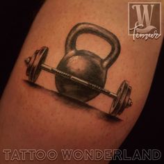 a tattoo with a kettle and barbell on it