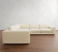 a white couch sitting on top of a wooden floor