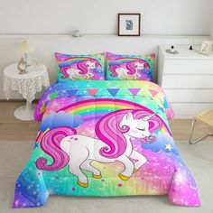 a bed room with a unicorn comforter and pillows