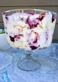 an ice cream sundae in a glass dish on a table