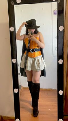 a woman is taking a selfie in front of a mirror with her hat on