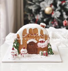 a gingerbread house is decorated with white icing and christmas decorations for the holiday season