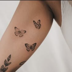 a woman's arm with three butterflies on it