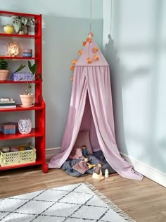 a child's play tent in the corner of a room with bookshelves