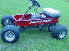 a red radio flyer sitting in the grass