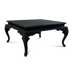 a black coffee table sitting on top of a white floor