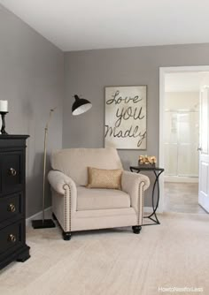 a living room with gray walls and white furniture