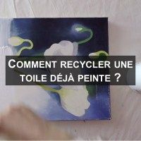 a person using a computer mouse on top of a piece of paper with the words comment recycler une toile deja peite?