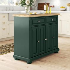 a green kitchen island with marble top