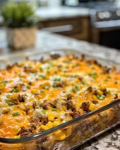 a casserole dish with meat and vegetables in it on a kitchen counter top