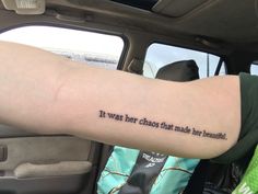 a person with a tattoo on their arm saying it was her chaos that made not beautiful