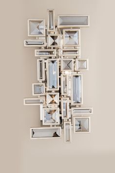 a mirror that is on the wall with many mirrors in it's centerpiece