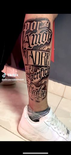 a man's leg with some type of lettering on it and the words above him