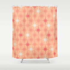 an orange shower curtain with red and white stars in the center, on a gray background