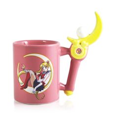 a pink coffee mug with a yellow handle and an anime character on it's side