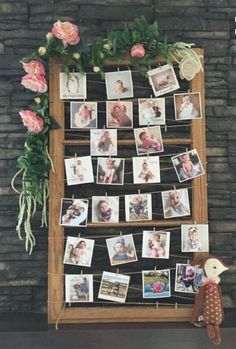 a wooden frame with pictures and flowers on it next to a stuffed animal toy in front of a stone wall