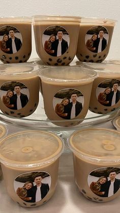 there are many cups with pictures on them in front of a cake platter filled with cupcakes