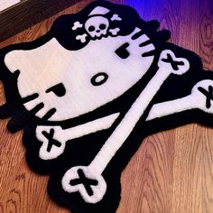 a hello kitty rug with a skull and cross bones on it